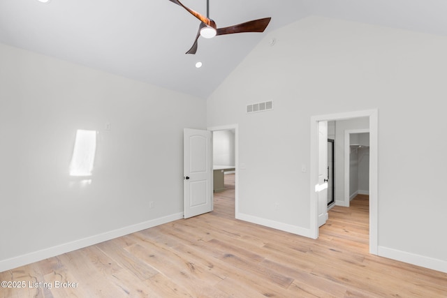 unfurnished bedroom with light wood finished floors, baseboards, a spacious closet, and visible vents