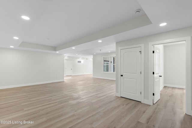 basement featuring recessed lighting, baseboards, and light wood finished floors