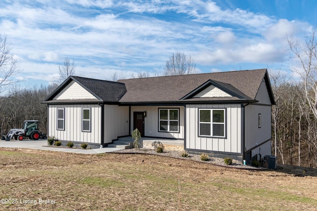 modern farmhouse with board and batten siding and roof with shingles