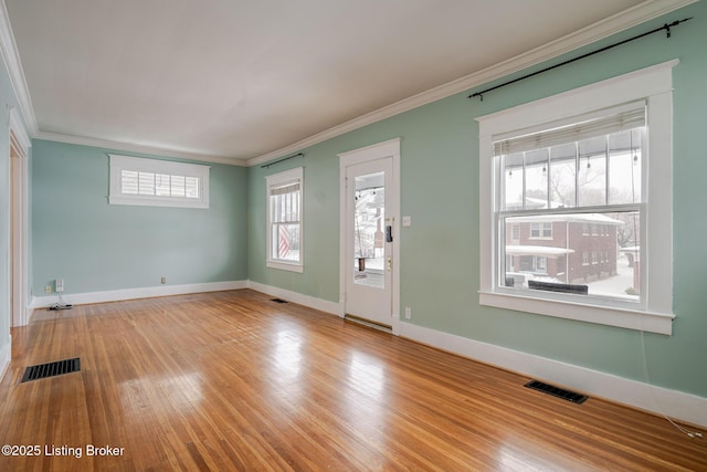 entryway with light hardwood / wood-style flooring and crown molding