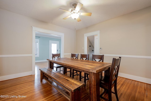 dining area featuring ceiling fan and wood-type flooring