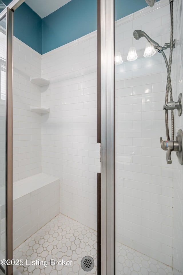 bathroom featuring a shower with door