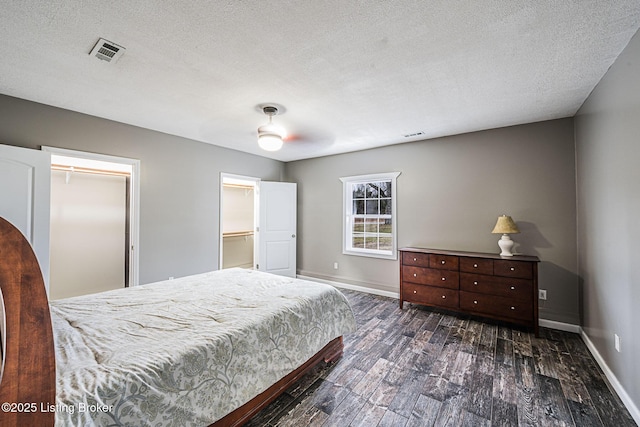 bedroom with dark wood-type flooring and a textured ceiling