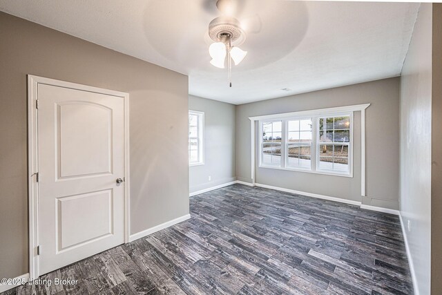 spare room featuring dark hardwood / wood-style floors and ceiling fan