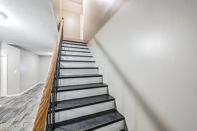 stairs featuring hardwood / wood-style floors