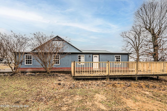 back of house with a deck