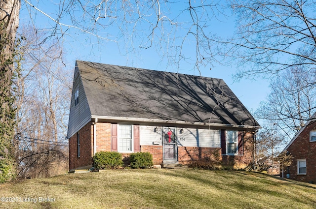 view of front of house with a front lawn and brick siding