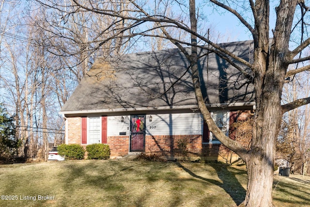 view of front of house with a front lawn and brick siding