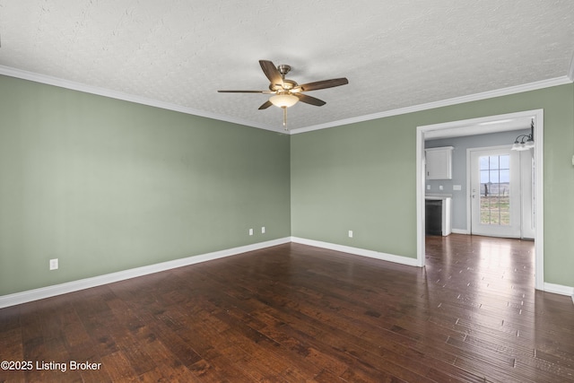 unfurnished room featuring hardwood / wood-style flooring, ceiling fan, baseboards, and crown molding