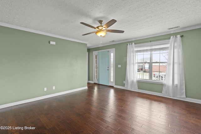 empty room with baseboards, visible vents, hardwood / wood-style flooring, a textured ceiling, and crown molding