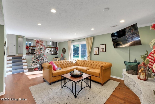 living room featuring a textured ceiling and hardwood / wood-style flooring