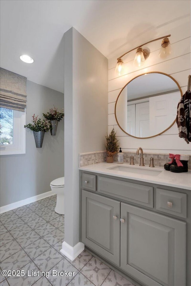 bathroom featuring vanity and toilet