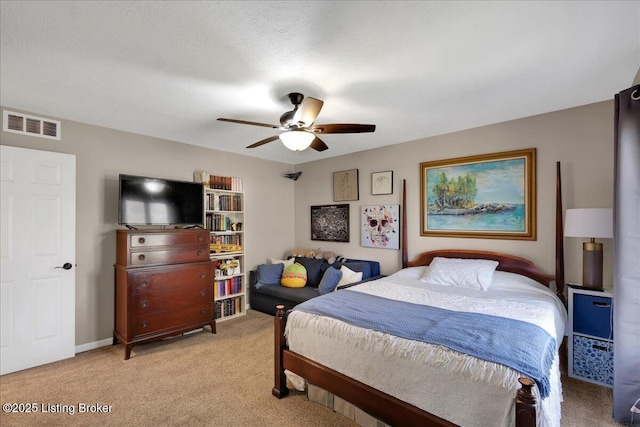 bedroom featuring ceiling fan and light carpet