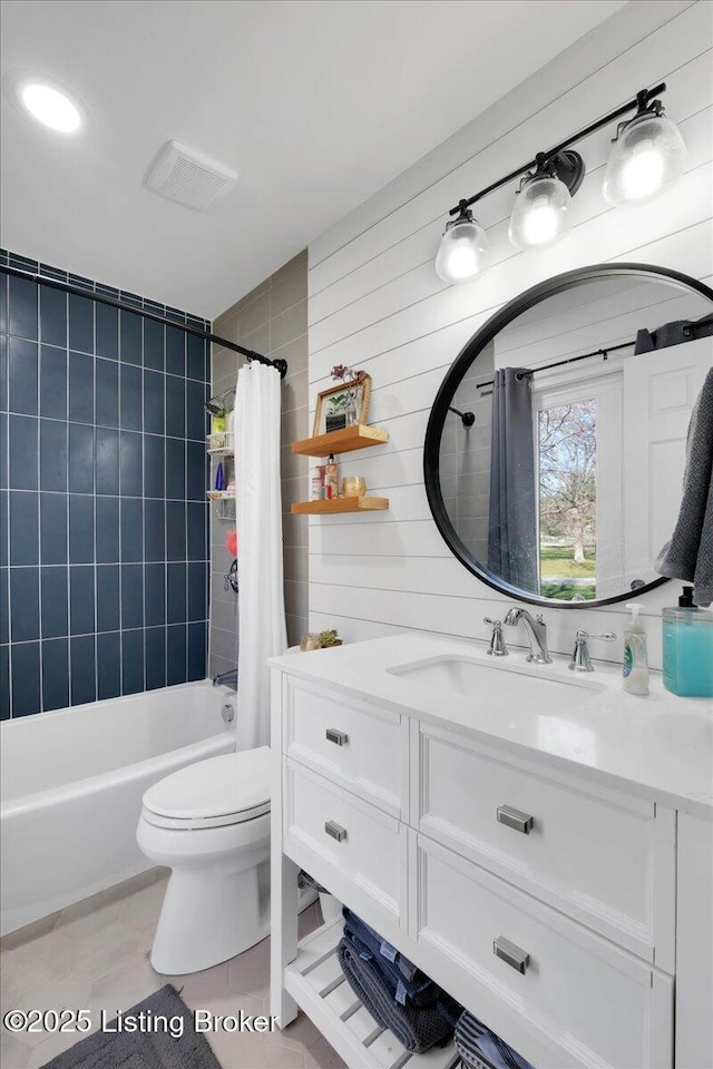 full bathroom featuring toilet, shower / bath combination with curtain, vanity, and tile patterned flooring