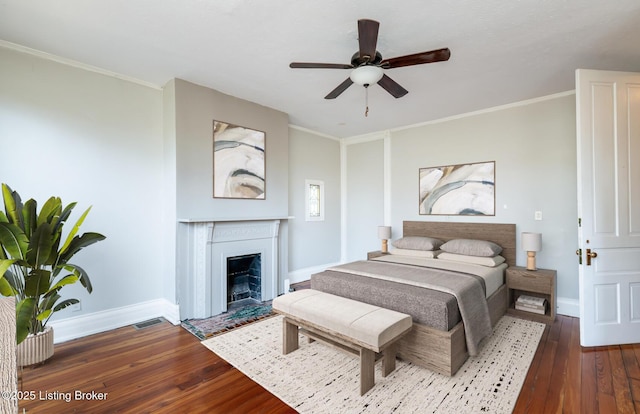 bedroom featuring ceiling fan, dark hardwood / wood-style floors, and ornamental molding