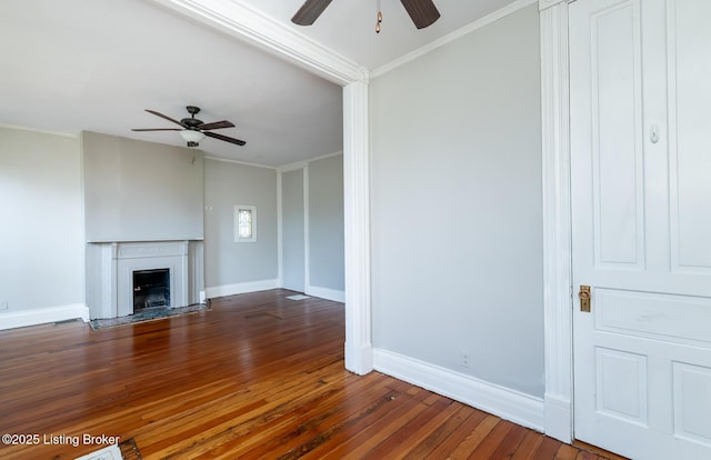 unfurnished living room featuring ceiling fan, crown molding, and dark hardwood / wood-style flooring