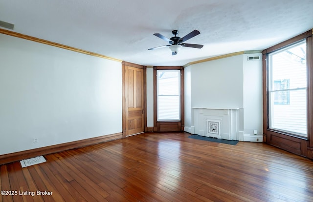 spare room with ornamental molding, dark wood-type flooring, a textured ceiling, and ceiling fan