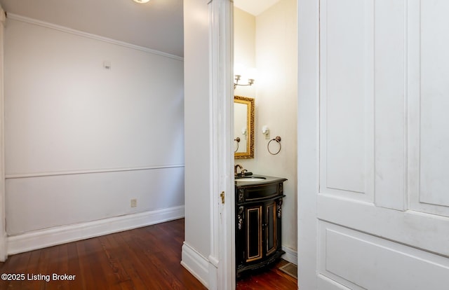 hallway with sink and dark wood-type flooring