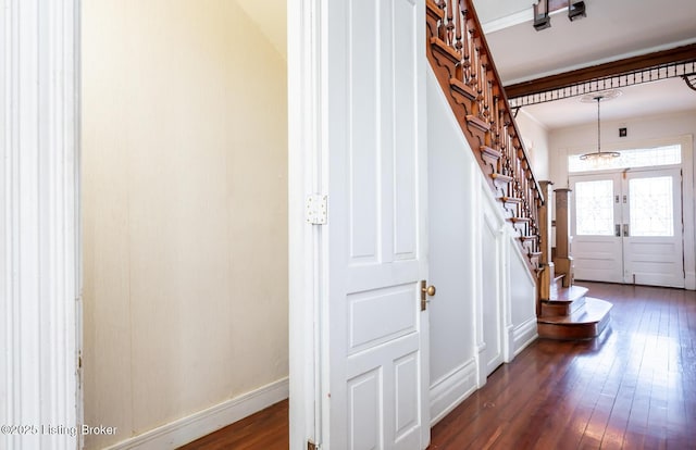 entryway featuring french doors, crown molding, and dark hardwood / wood-style floors