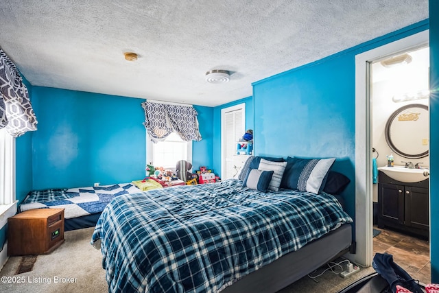 bedroom featuring sink and a textured ceiling