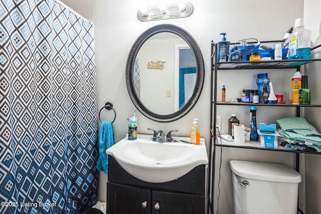 bathroom featuring toilet and vanity