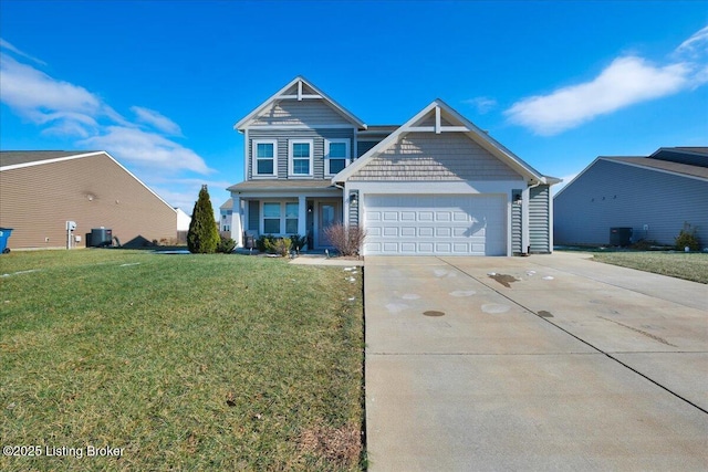 view of front of home with a front lawn, cooling unit, and a garage