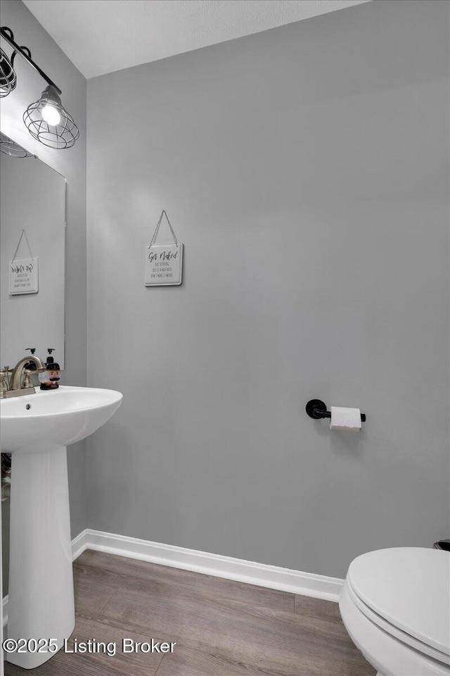 bathroom featuring hardwood / wood-style floors, sink, and toilet