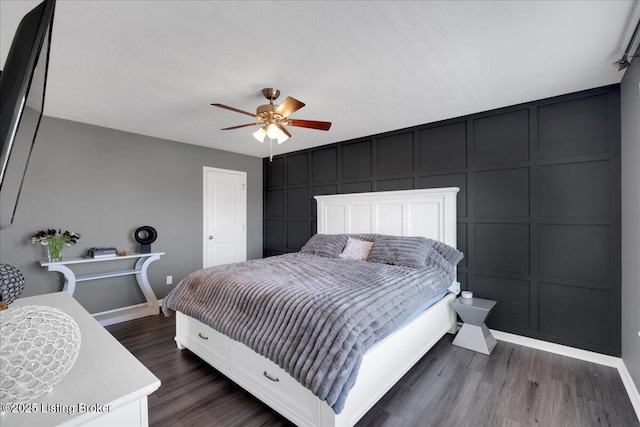 bedroom with dark wood-type flooring and ceiling fan