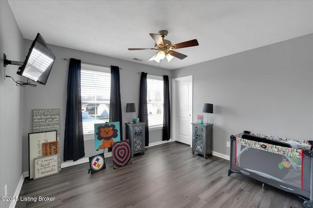 interior space featuring ceiling fan and dark hardwood / wood-style floors