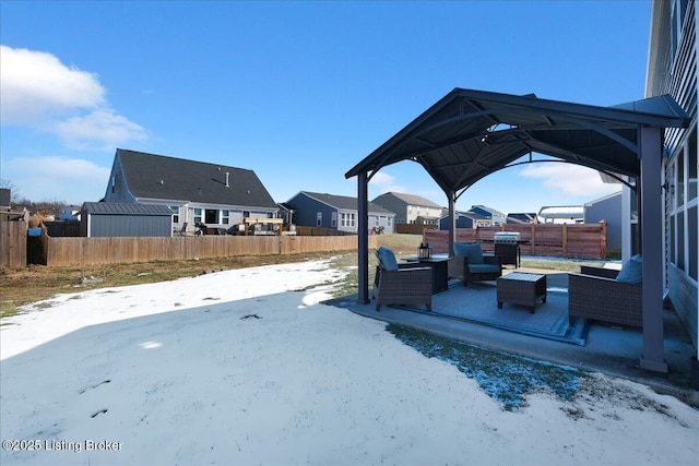 yard covered in snow with outdoor lounge area