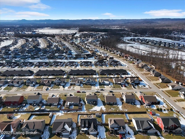 snowy aerial view with a mountain view