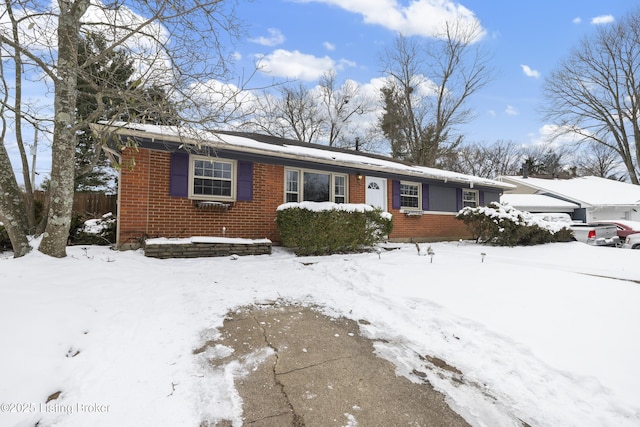 ranch-style home with a garage and brick siding