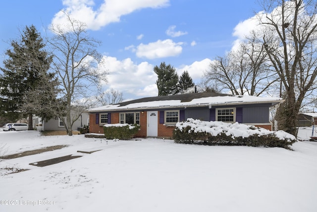 ranch-style home featuring brick siding