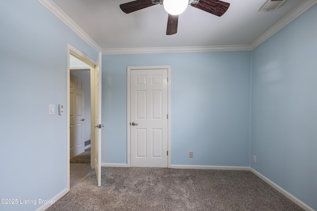 empty room featuring crown molding, light colored carpet, visible vents, a ceiling fan, and baseboards