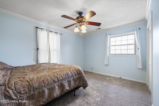 bedroom with a textured ceiling, carpet flooring, visible vents, baseboards, and ornamental molding