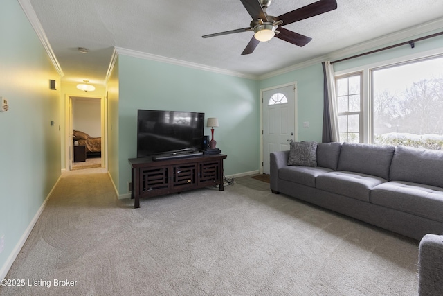 living area featuring a textured ceiling, light carpet, a ceiling fan, baseboards, and crown molding