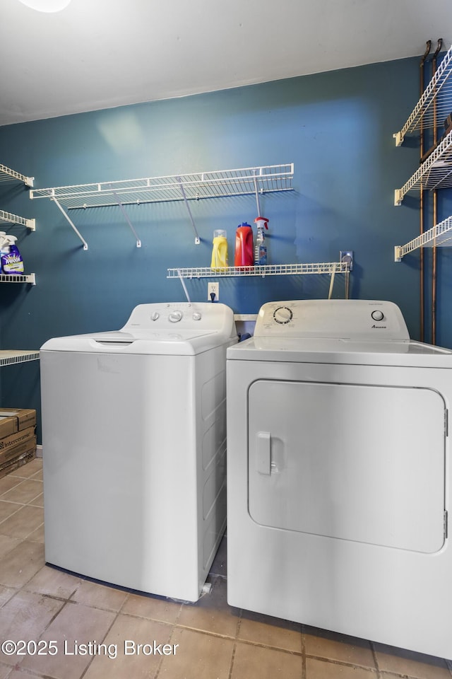 clothes washing area featuring laundry area, tile patterned flooring, and independent washer and dryer