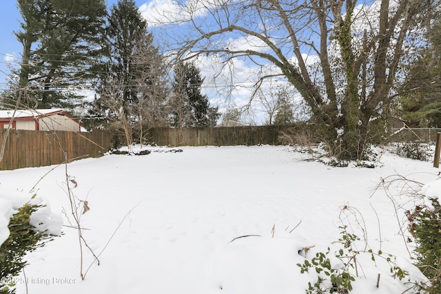 yard covered in snow with fence