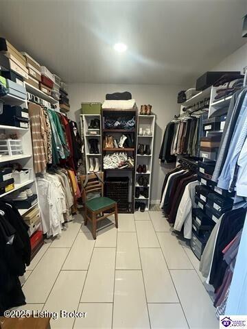 spacious closet with tile patterned floors