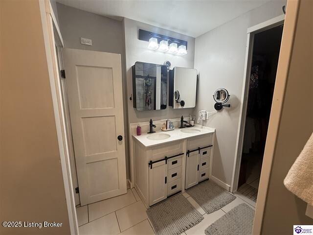 bathroom with tile patterned floors and vanity