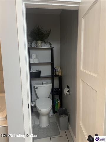 bathroom featuring toilet and tile patterned flooring