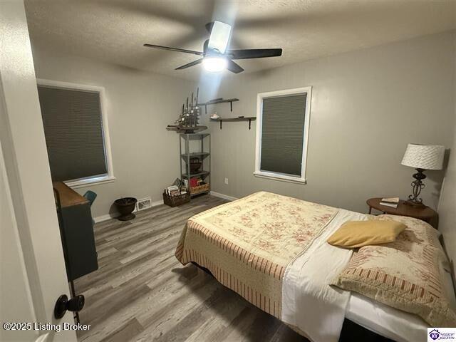 bedroom with hardwood / wood-style flooring and ceiling fan