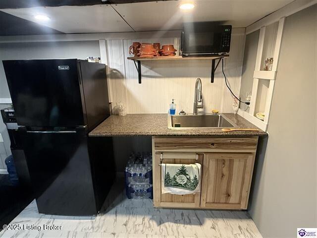 kitchen featuring sink and black appliances