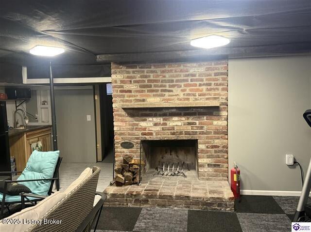 living room with a fireplace and sink