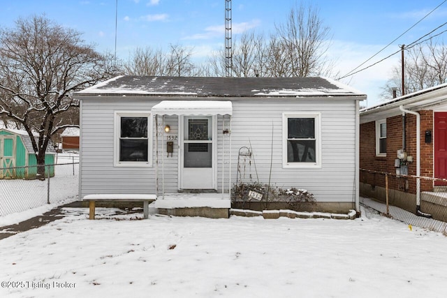 bungalow-style home featuring fence