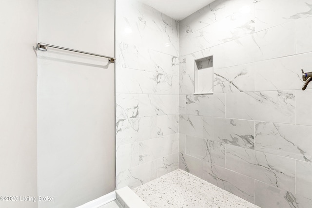 bathroom featuring tiled shower