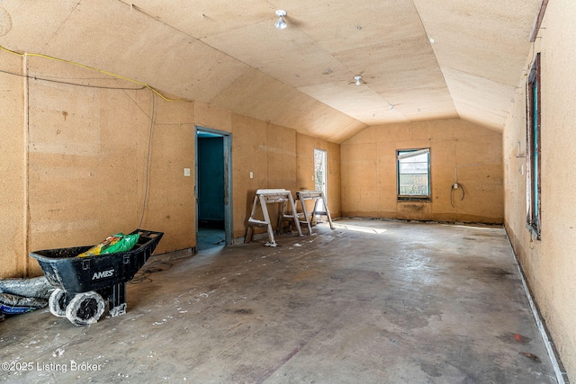 bonus room featuring concrete floors and vaulted ceiling