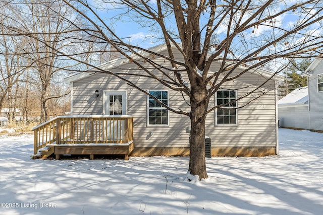 snow covered house with a deck