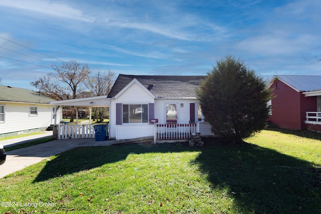 ranch-style home with a front yard and a carport