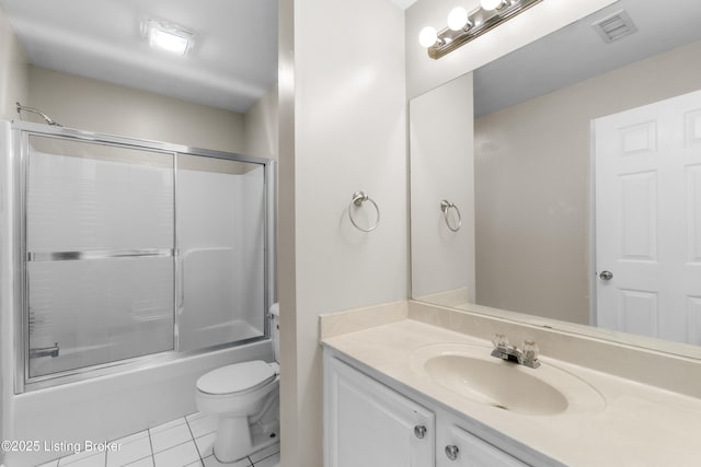 bathroom featuring visible vents, bath / shower combo with glass door, toilet, tile patterned floors, and vanity